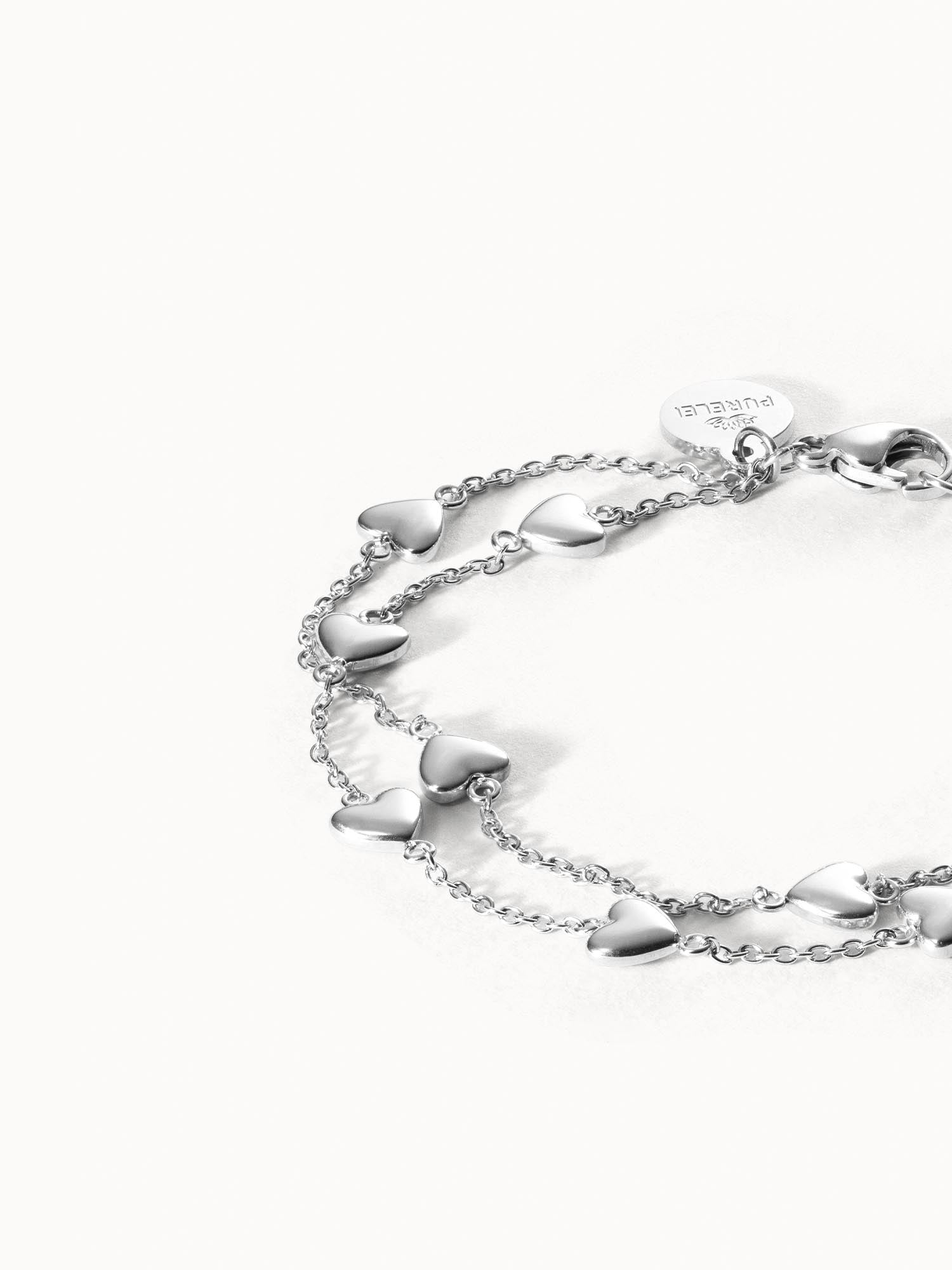 Alohi Heart Armband aus nickelfreiem Silber mit zarten Herzen, elegant inszeniert auf weißem Hintergrund von PURELEI
