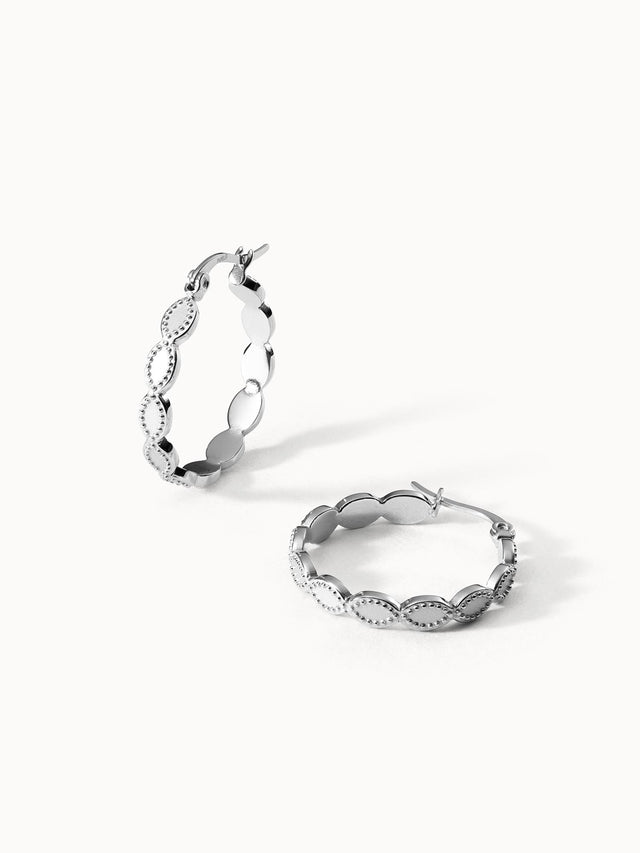 Silberne Creolen mit geschwungenem Design von PURELEI, elegant und modern.