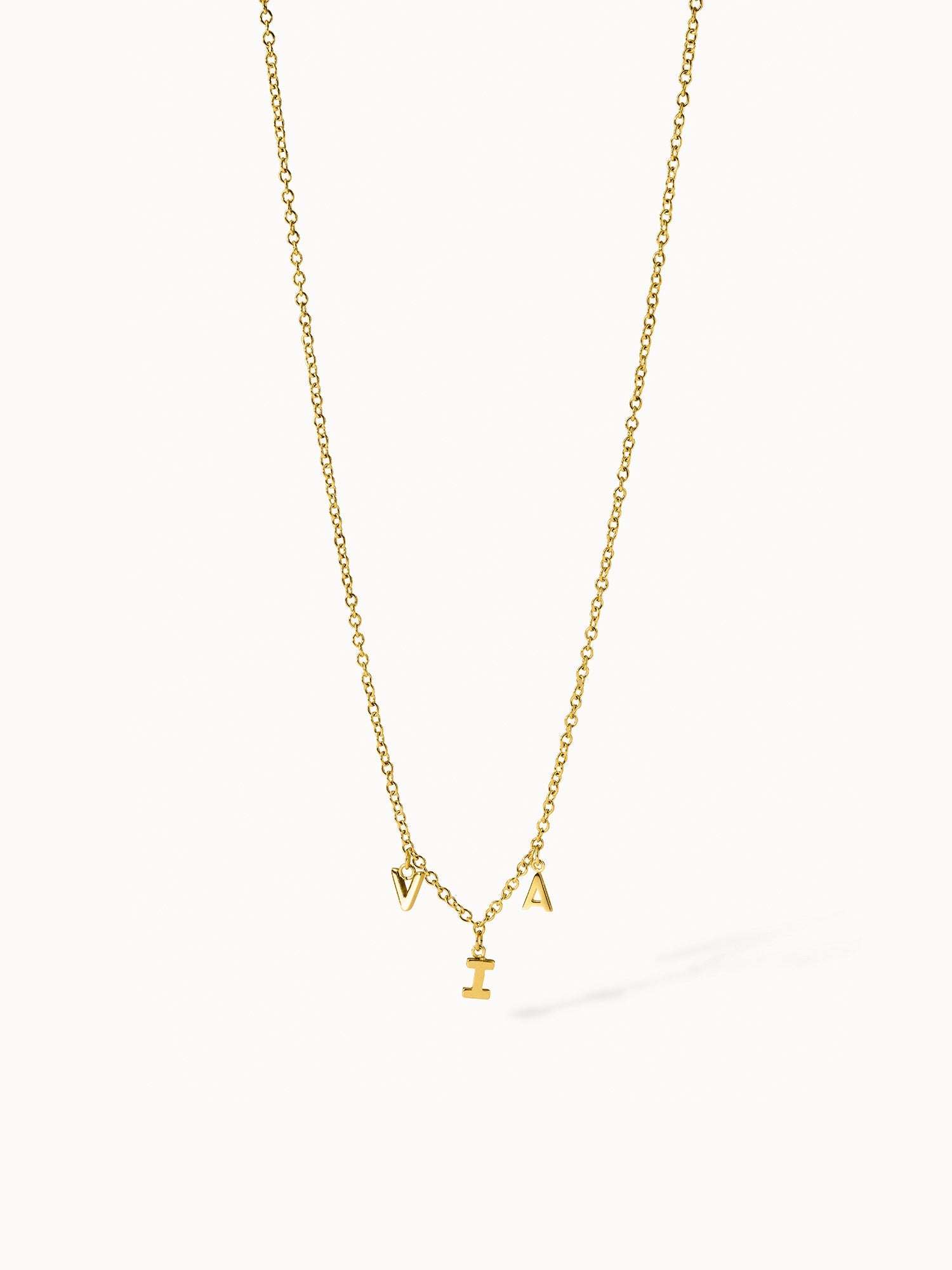 Goldene PURELEI Kette mit Buchstabenanhängern, elegant und verspielt.