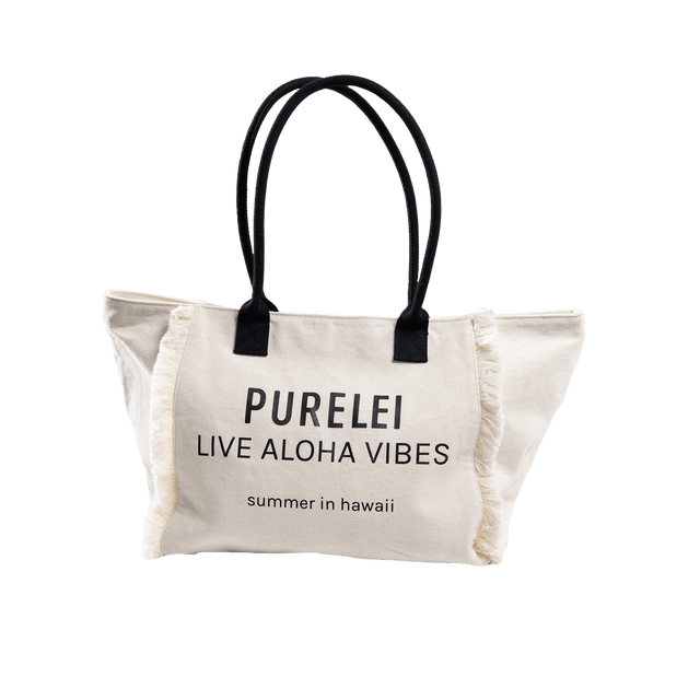 Beige Baumwolltasche mit schwarzem Druck, fransigen Kanten, PURELEI Aloha-Vibes.
