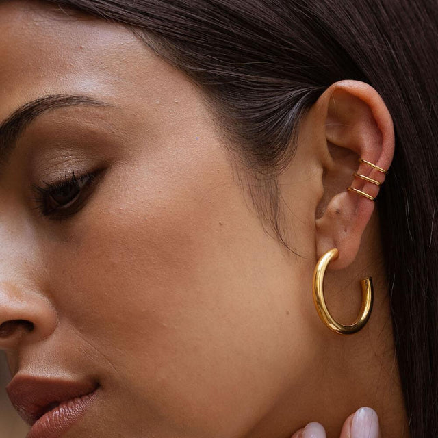 PURELEI Kumu O Creolen aus 18K Gold, 30 mm groß, am Ohr getragen mit edler, schlichter Eleganz.