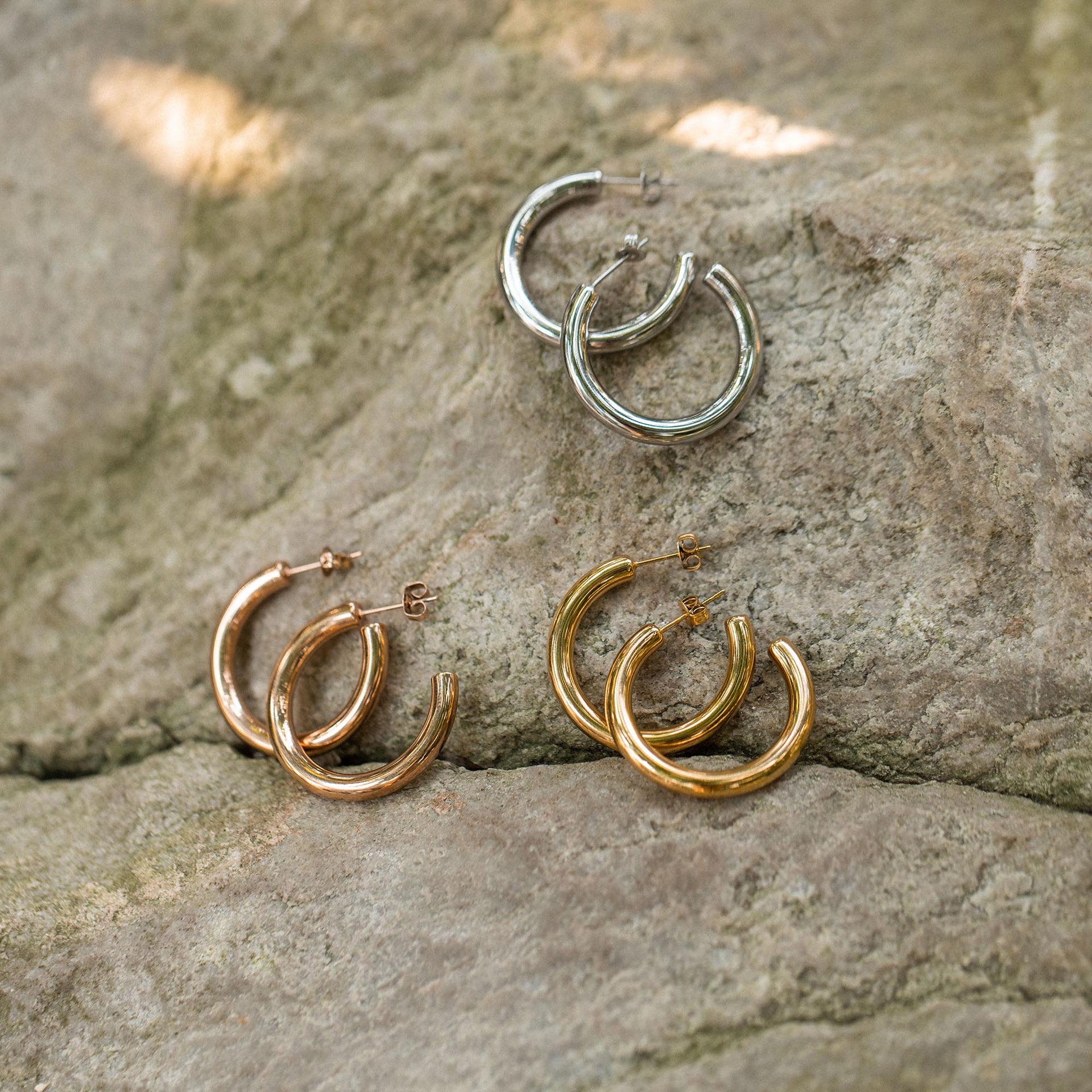 PURELEI Kumu O Creolen in Gold, Silber und Roségold auf Naturstein, clean & elegant präsentiert.