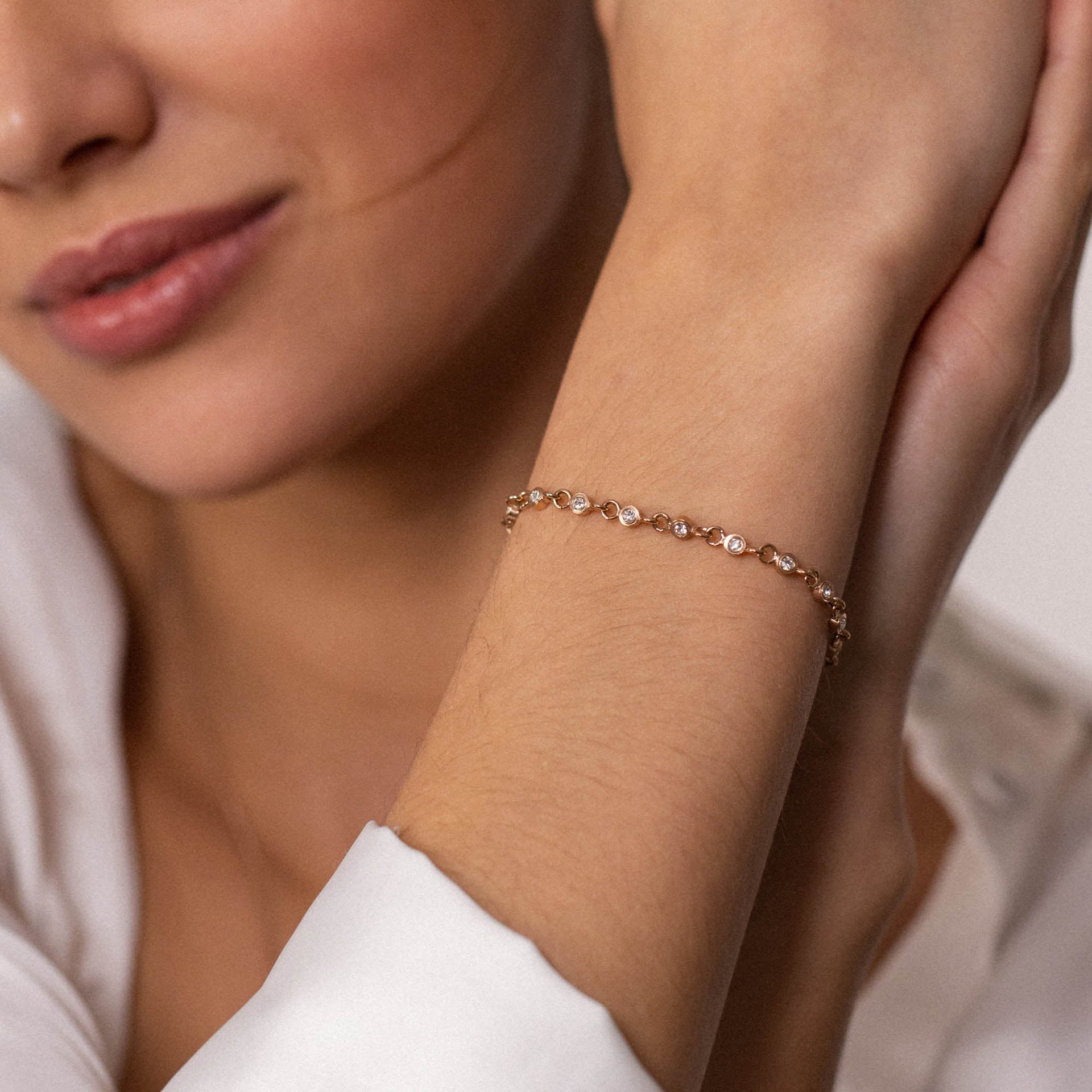 Roségoldenes Armband mit funkelnden Steinen, getragen am Handgelenk, PURELEI.
